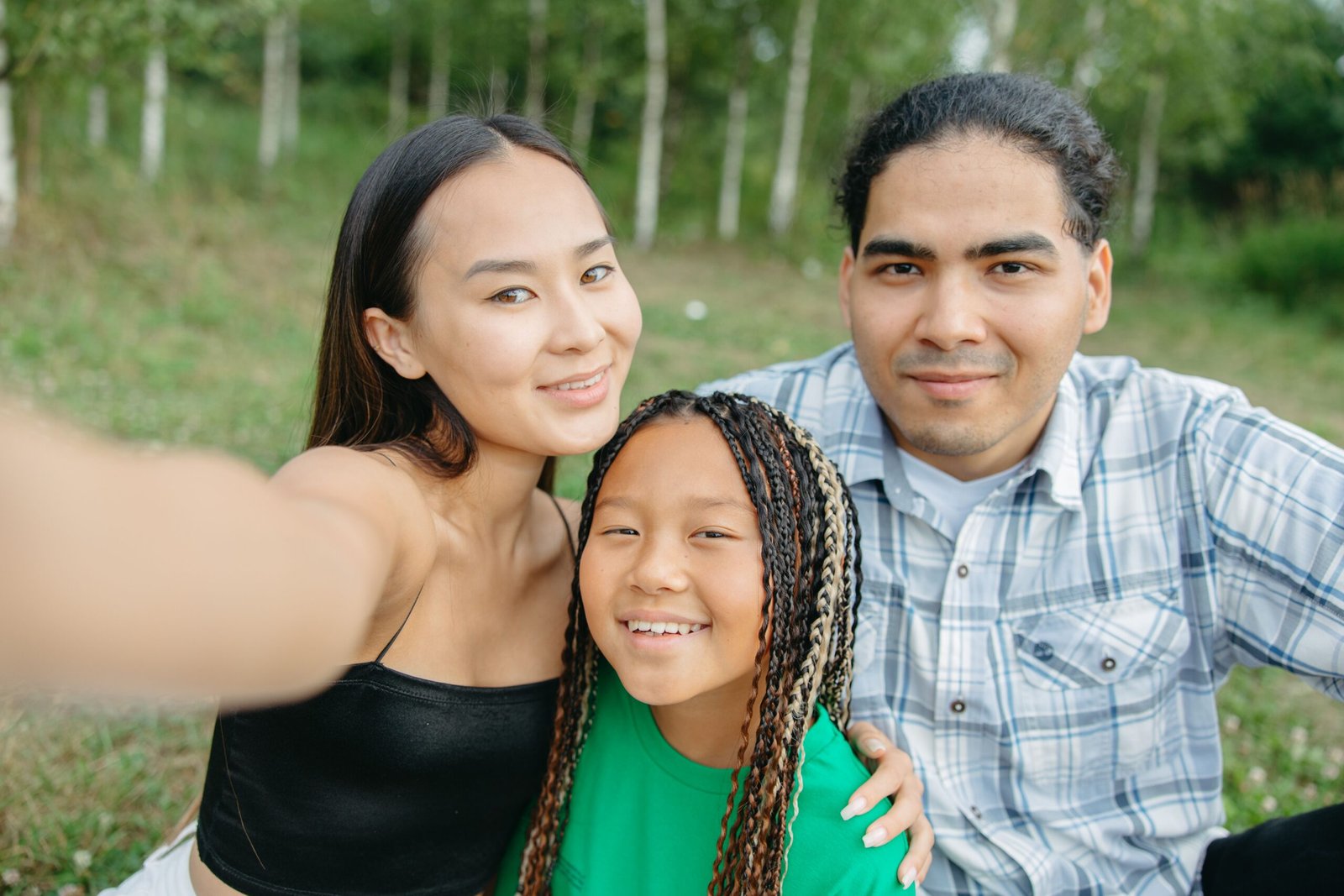 A family taking a selfie outdoors