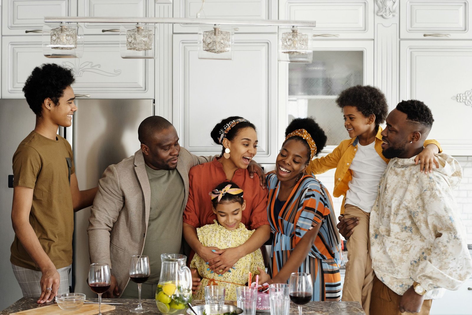 A family laughing together in a bright kitchen
