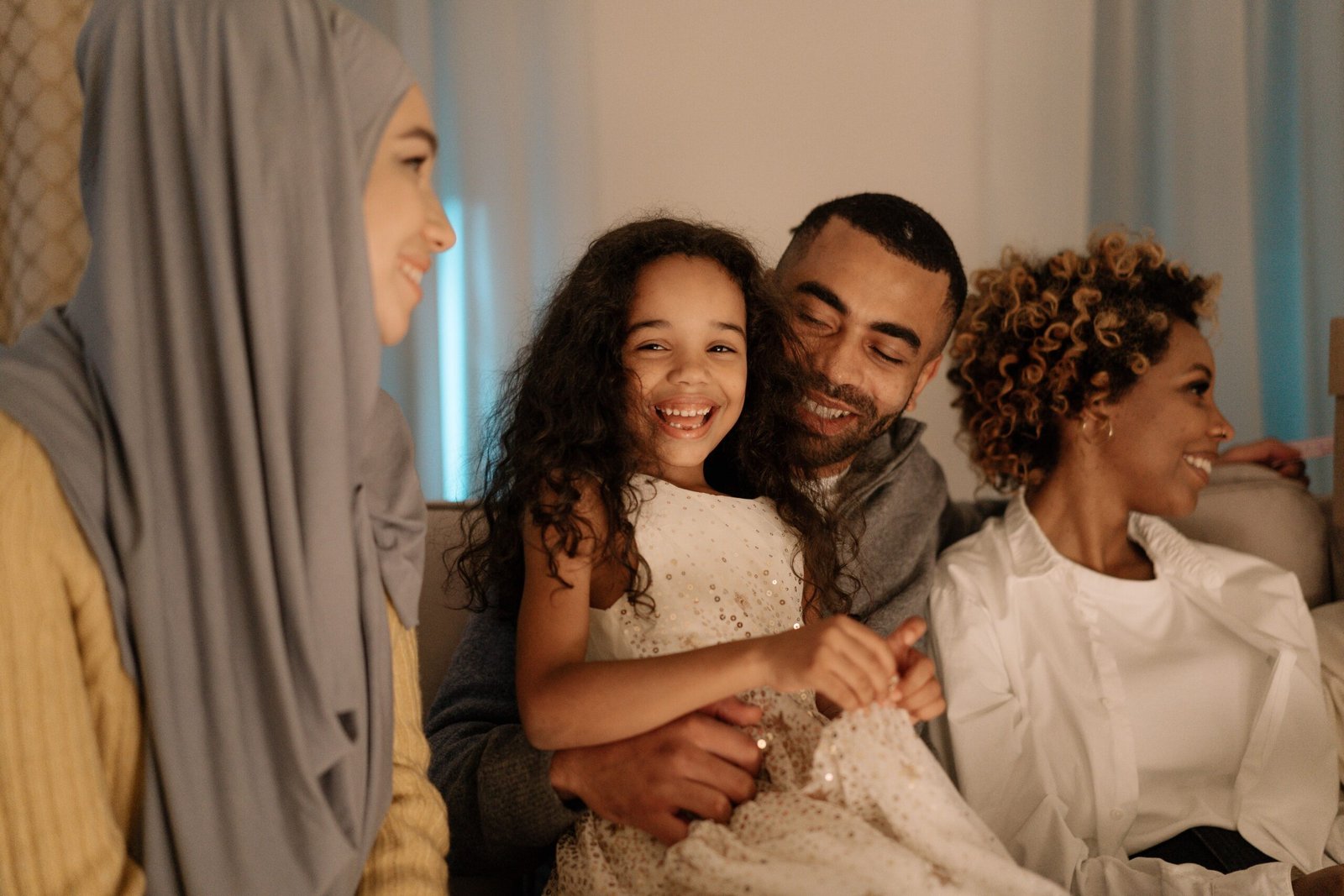A family smiling together on a sofa