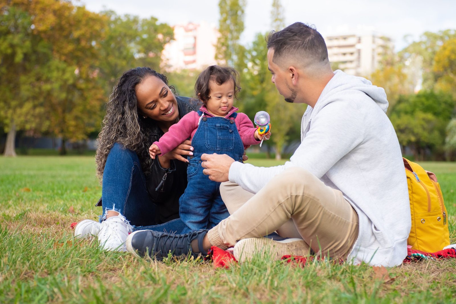 Parents sitting in the park with their toddler