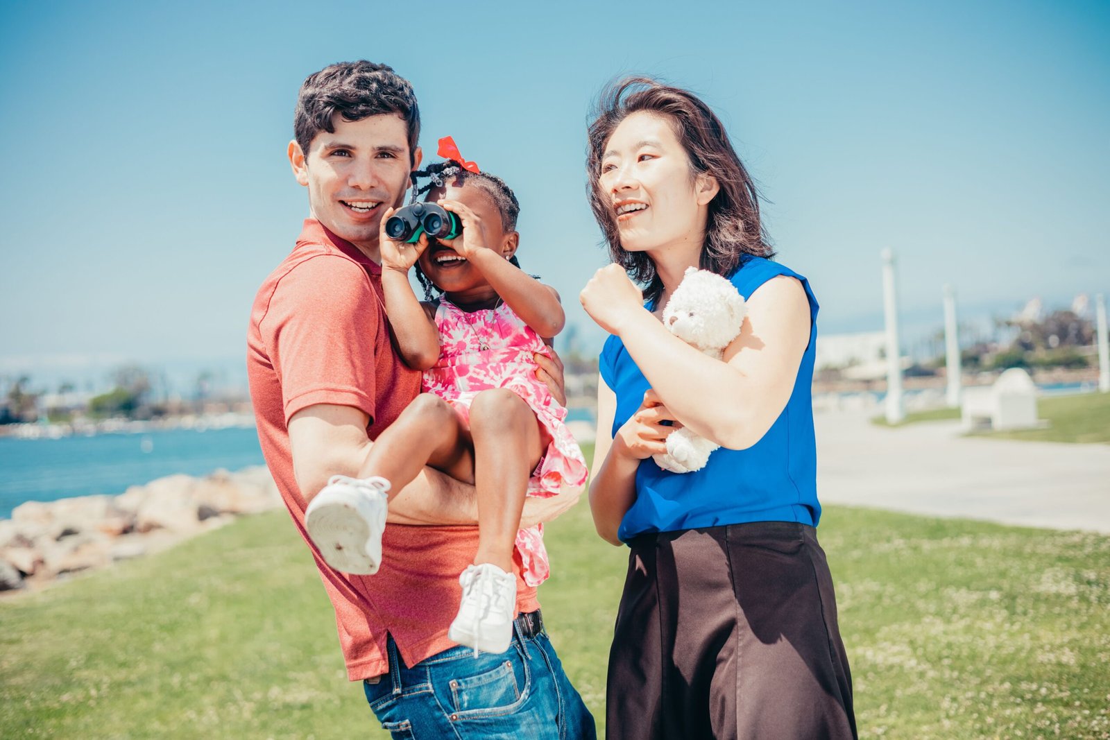 A family standing together by the water
