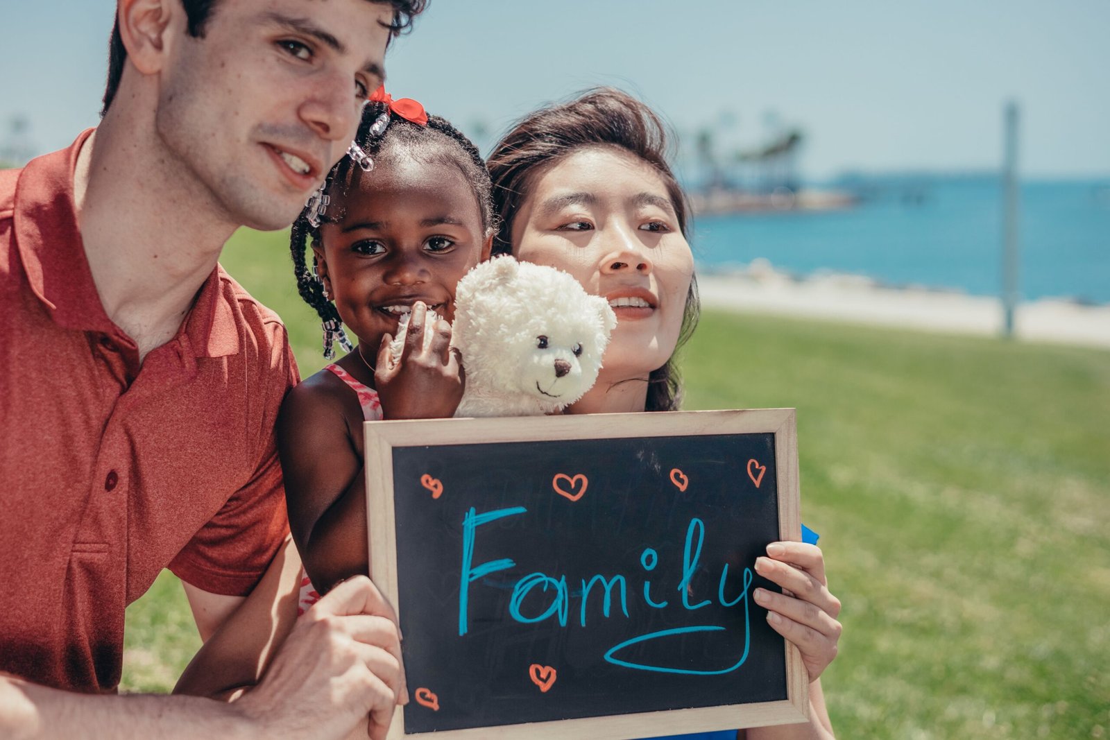 A family holding a sign that says Family